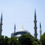 Stunning view of the Blue Mosque's domes and minarets against a clear sky in Istanbul.