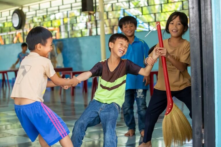 Happy children playing together in Vinh Son shelter, Kon Tum, showcasing friendship and fun.