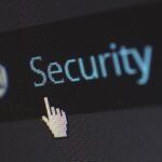 Close-up view of a mouse cursor over digital security text on display.