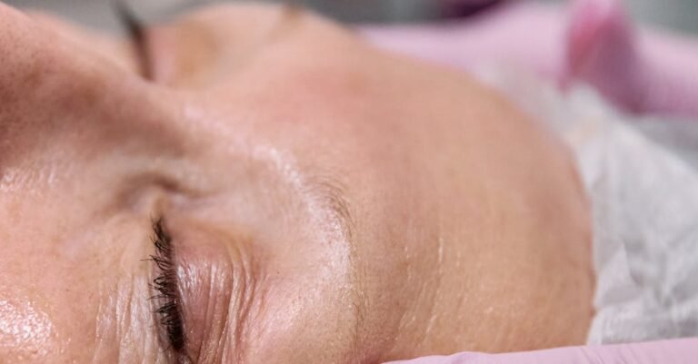 Close-up of a senior woman receiving a relaxing facial treatment in a spa setting.