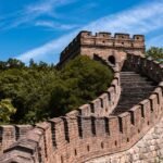 part of the great wall of china with stairs to the watchtower on the hill