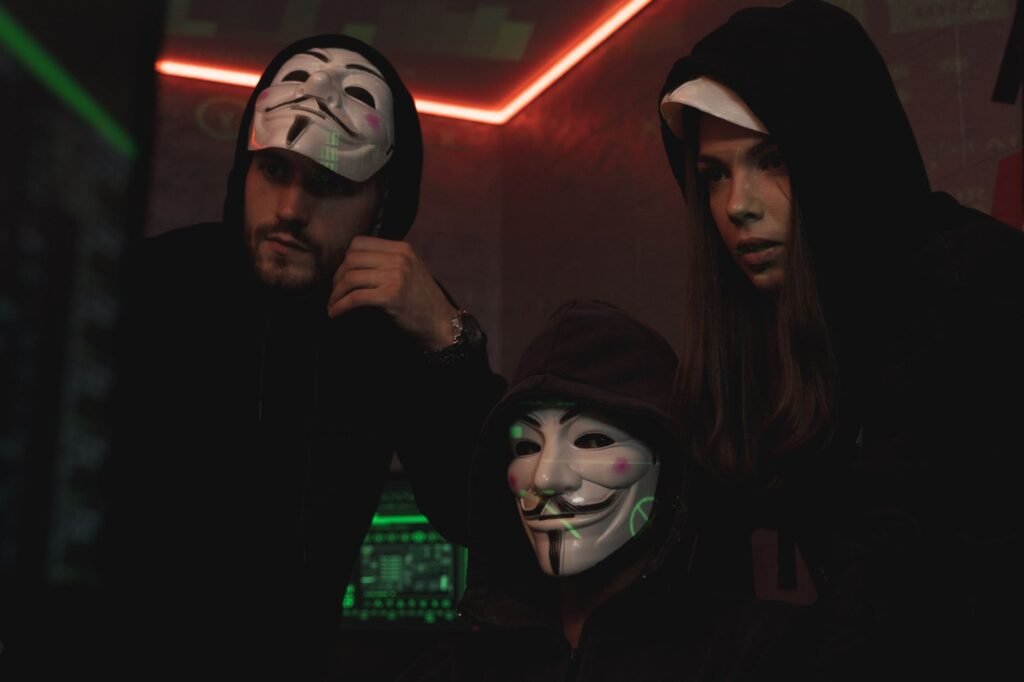 three people hacking a computer system