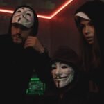 three people hacking a computer system