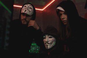three people hacking a computer system